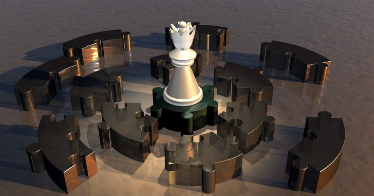 Logic Models & Theories of Change represented by a strategic chess piece placed on top of interlocking puzzle pieces.