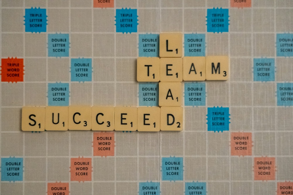 Scrabble tiles spelling team and succeed, representing how organizations build a data culture